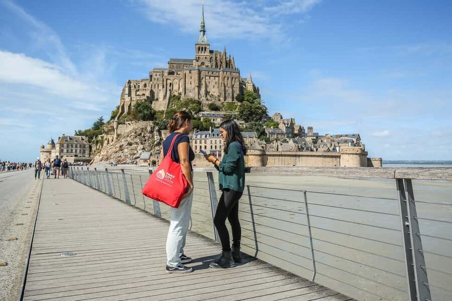 From Paris: Full-Day Mont Saint-Michel Guided Tour - Parking, shuttle, and the first views from the wood bridge