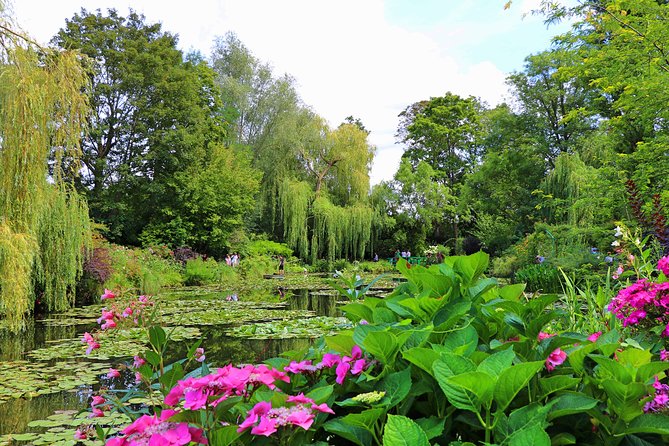 Giverny and Monet's Garden Half-Day Trip from Paris - The Water Garden and Japanese Bridge: sky, water, and timed quiet