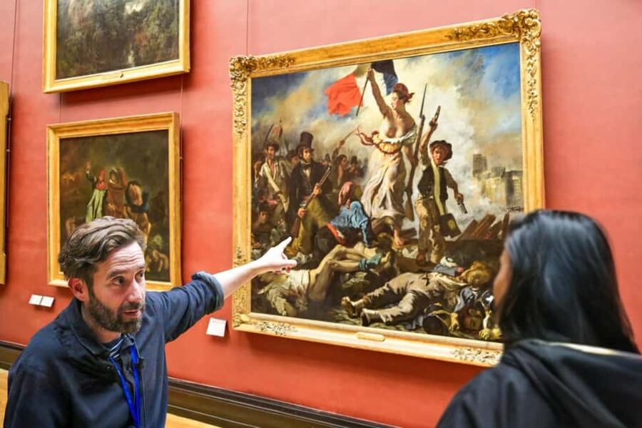 Paris: Skip-the-Line Louvre Museum & Mona Lisa Guided Tour - Meeting at the Louvre Pyramid: Louis XIV and the Tour Guy sign
